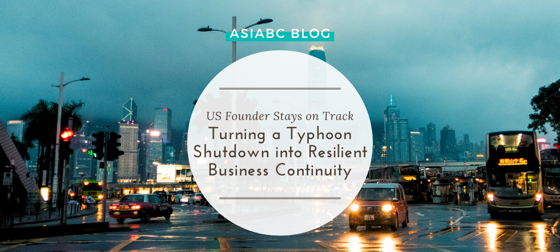 Blog Banner - US Founder Stays on Track Turning a Typhoon Shutdown into Resilient Business Continuity Rainy street in Hong Kong during typhoon season showing AsiaBC’s resilience for banking continuity on business disruption.